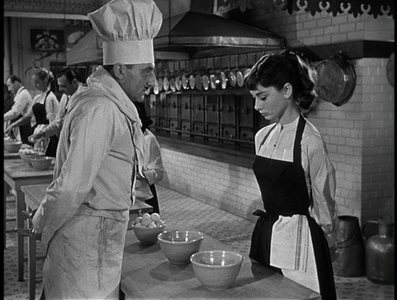 Audrey Hepburn ponders how to properly crack an egg in "Sabrina"